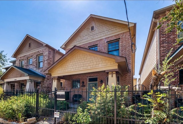 5303 Nett St Unit A, Houston, TX 77007 - view of front of house with a fenced front yard, brick siding, and covered porch