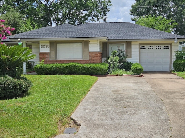 5218 Cortelyou Ln, Houston, TX 77021 - view of front facade featuring driveway, a front lawn, roof with shingles, an attached garage, and brick siding