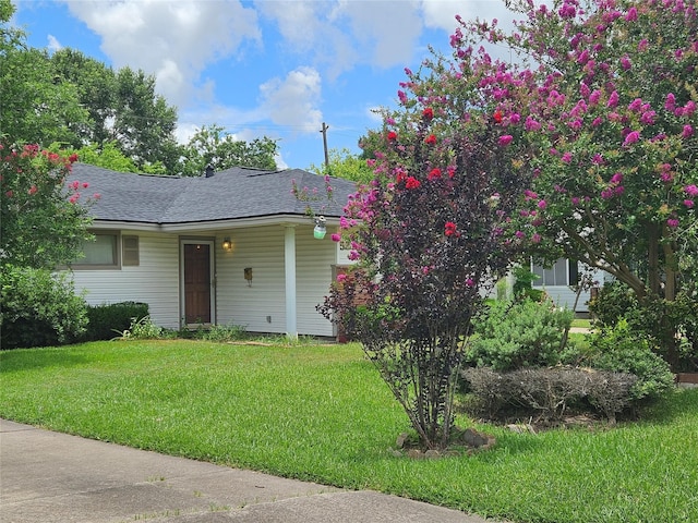 5218 Cortelyou Ln, Houston, TX 77021 - view of front of house with a front yard and roof with shingles