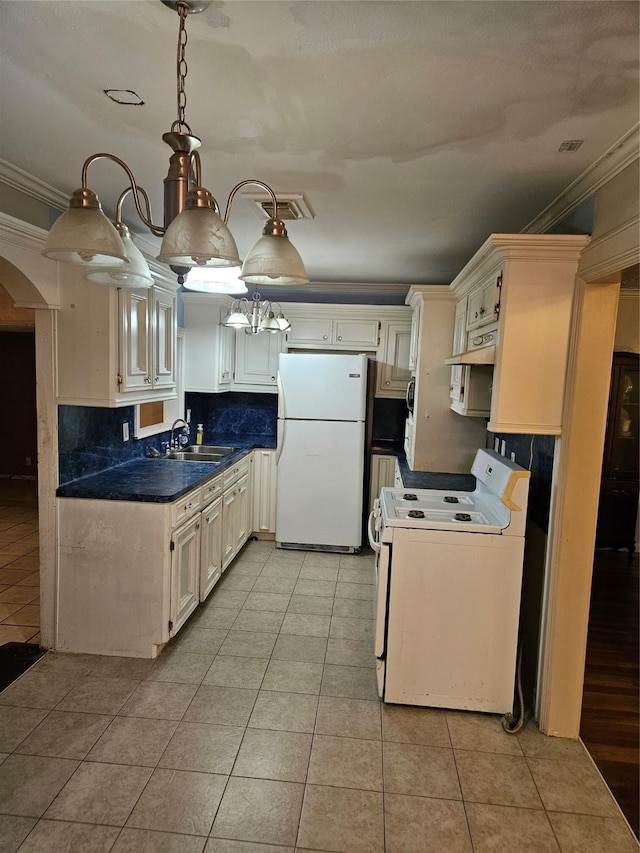 5218 Cortelyou Ln, Houston, TX 77021 - kitchen with white appliances, crown molding, arched walkways, light tile patterned floors, and backsplash