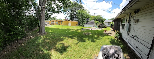 5218 Cortelyou Ln, Houston, TX 77021 - view of green lawn featuring a storage shed