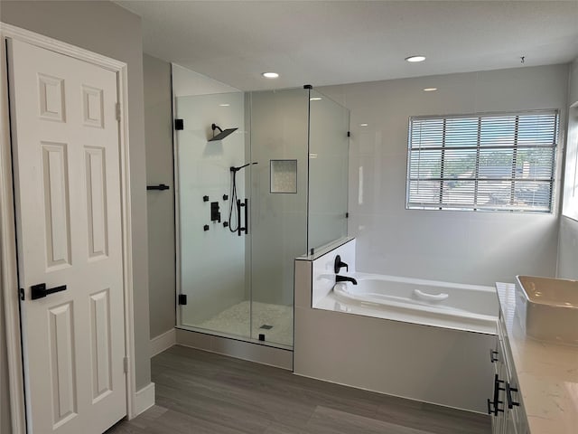 2922 Field Line Dr, Sugar Land, TX 77479 - full bathroom featuring a stall shower, a bath, wood finished floors, and vanity