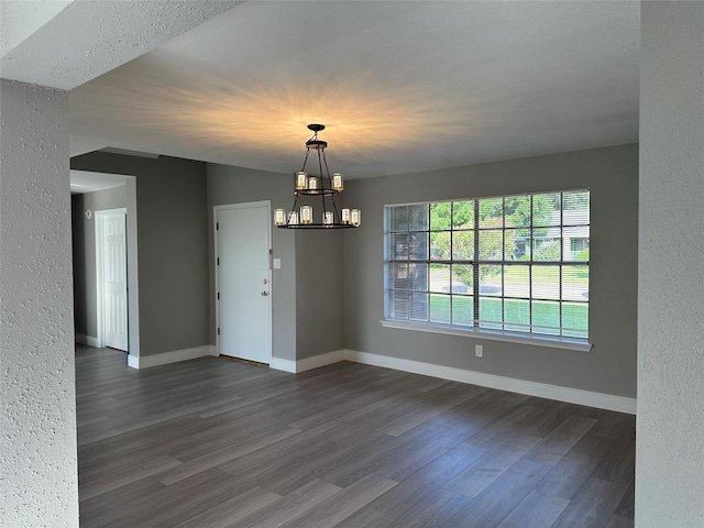 2922 Field Line Dr, Sugar Land, TX 77479 - spare room featuring dark wood finished floors, a chandelier, and a textured wall