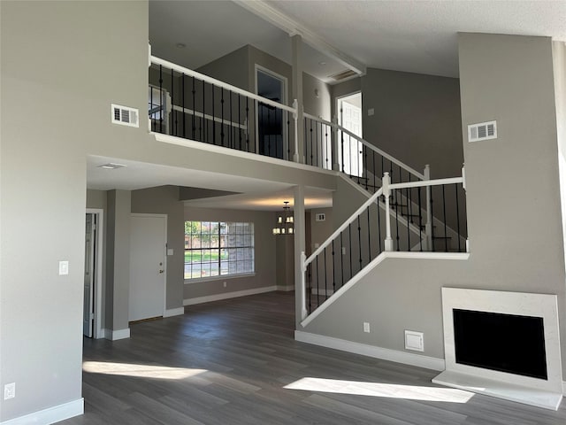 2922 Field Line Dr, Sugar Land, TX 77479 - unfurnished living room with high vaulted ceiling, wood finished floors, and stairway