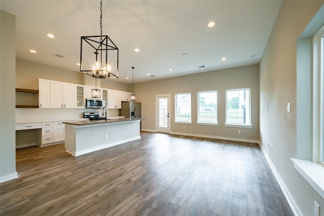 11325 Stonework Garden Ln, Houston, TX 77076 - kitchen with stainless steel appliances, open shelves, a center island with sink, white cabinets, and recessed lighting
