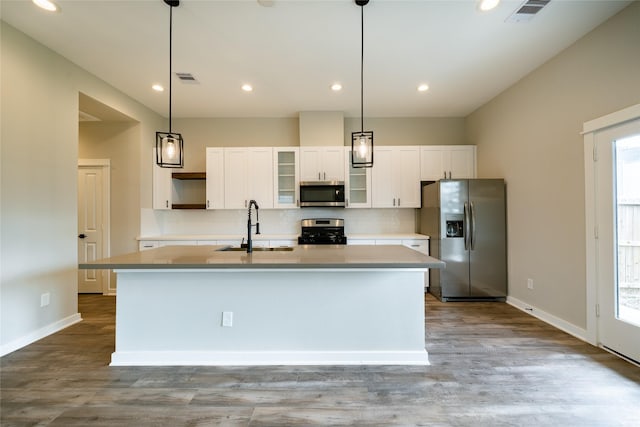 11325 Stonework Garden Ln, Houston, TX 77076 - kitchen featuring stainless steel appliances, an island with sink, decorative backsplash, white cabinets, and light countertops