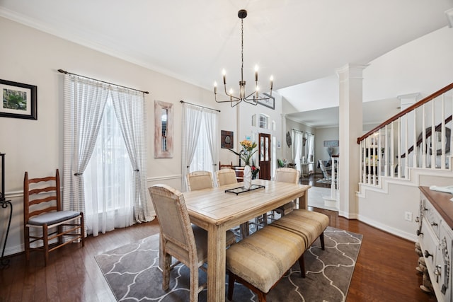 1155 Rustling Wind Ln, League City, TX 77573 - dining room with hardwood / wood-style floors, a chandelier, stairs, and ornate columns