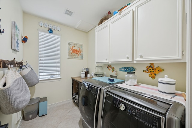 1155 Rustling Wind Ln, League City, TX 77573 - laundry room with cabinet space, washer and dryer, and light tile patterned floors
