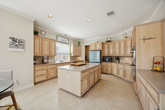 1155 Rustling Wind Ln, League City, TX 77573 - kitchen with light brown cabinetry, freestanding refrigerator, a kitchen island, tasteful backsplash, and crown molding