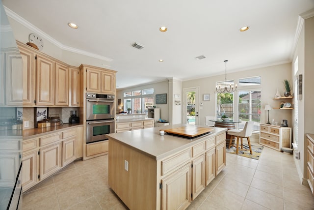 1155 Rustling Wind Ln, League City, TX 77573 - kitchen with double oven, a center island, light tile patterned floors, recessed lighting, and light brown cabinets