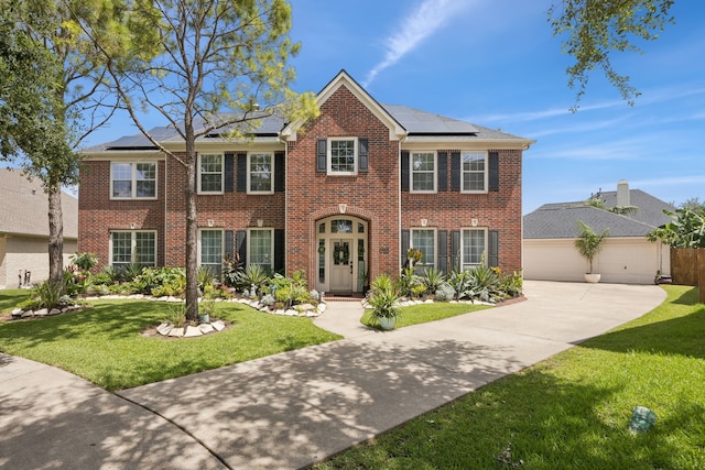 1155 Rustling Wind Ln, League City, TX 77573 - colonial inspired home with brick siding, concrete driveway, and a front lawn
