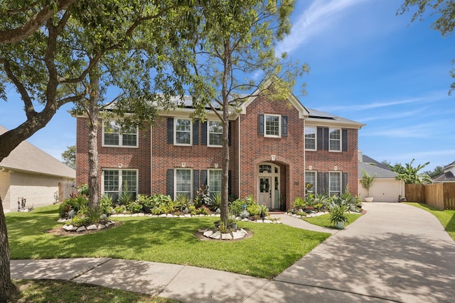 1155 Rustling Wind Ln, League City, TX 77573 - view of front facade with brick siding, roof mounted solar panels, concrete driveway, and a garage