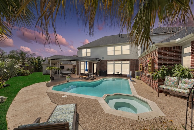 1155 Rustling Wind Ln, League City, TX 77573 - pool at dusk with a patio area, a pool with connected hot tub, outdoor dining area, and a lawn