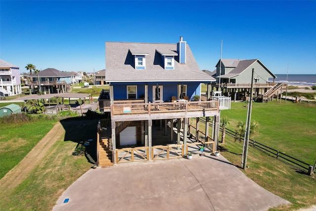 862 Gregory Ln, Port Bolivar, TX 77650 - back of house with stairway, a chimney, a carport, and a deck with water view