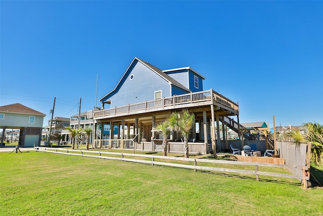 862 Gregory Ln, Port Bolivar, TX 77650 - back of property featuring a yard and a wooden deck