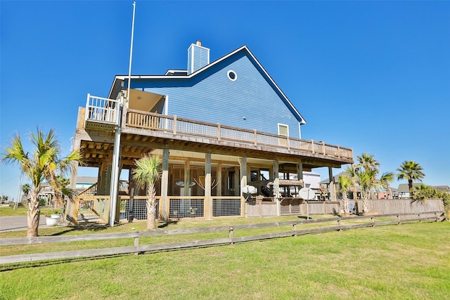 862 Gregory Ln, Port Bolivar, TX 77650 - back of house with a wooden deck and a chimney