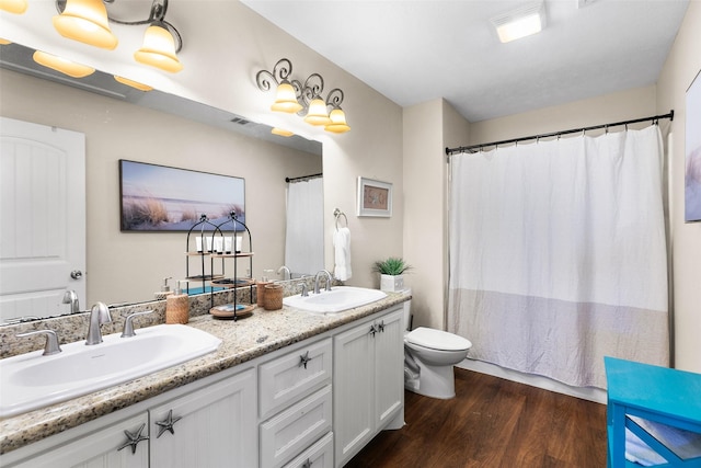 862 Gregory Ln, Port Bolivar, TX 77650 - bathroom with wood finished floors, double vanity, and a shower with curtain