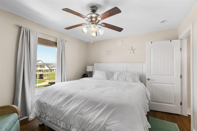 862 Gregory Ln, Port Bolivar, TX 77650 - bedroom with dark wood-style floors and a ceiling fan