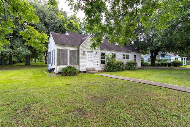 714 E Rogers St, Houston, TX 77022 - view of front of property with entry steps, a front lawn, and a shingled roof