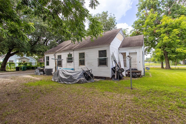 714 E Rogers St, Houston, TX 77022 - rear view of house featuring a lawn and a shingled roof