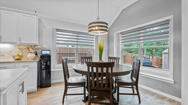 4542 Shallow Ember Dr, Spring, TX 77386 - dining room featuring lofted ceiling, a chandelier, healthy amount of natural light, ornamental molding, and light wood-style floors
