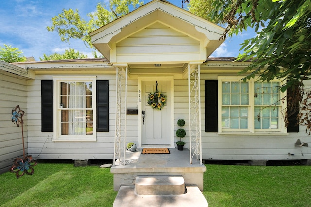 418 Forrest St, Baytown, TX 77520 - view of exterior entry with a lawn
