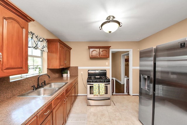 418 Forrest St, Baytown, TX 77520 - kitchen featuring appliances with stainless steel finishes, tasteful backsplash, brown cabinetry, and light tile patterned floors