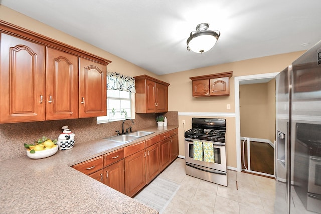 418 Forrest St, Baytown, TX 77520 - kitchen with appliances with stainless steel finishes, backsplash, light tile patterned flooring, and brown cabinets