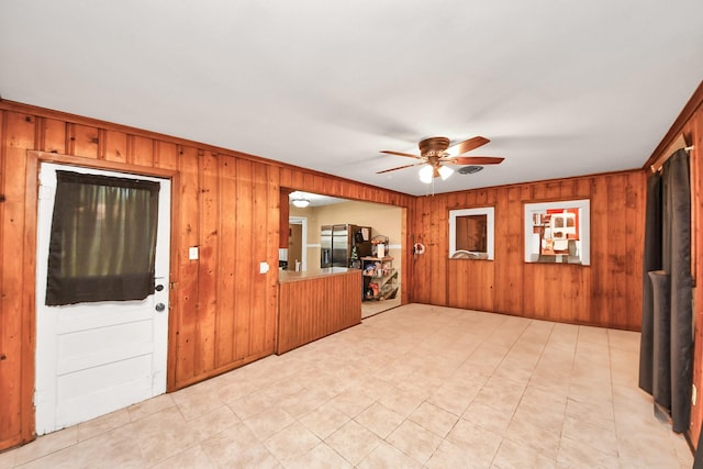 418 Forrest St, Baytown, TX 77520 - unfurnished living room featuring a ceiling fan and wooden walls