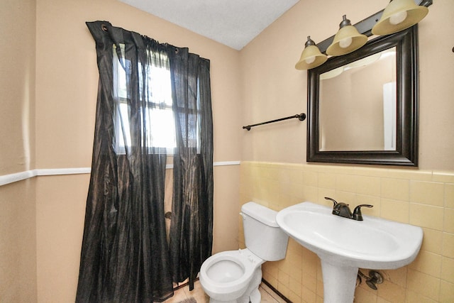 418 Forrest St, Baytown, TX 77520 - bathroom featuring tile walls and a wainscoted wall