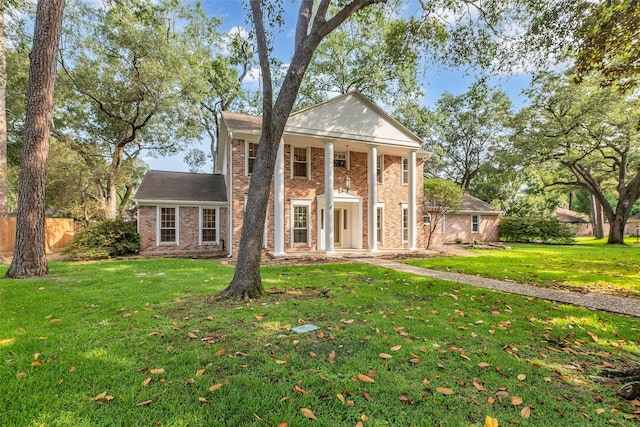 13631 Balmore Cir, Houston, TX 77069 - neoclassical / greek revival house featuring brick siding, a front yard, and covered porch