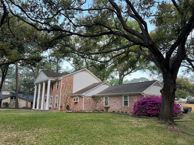 13631 Balmore Cir, Houston, TX 77069 - view of side of home featuring brick siding and a lawn