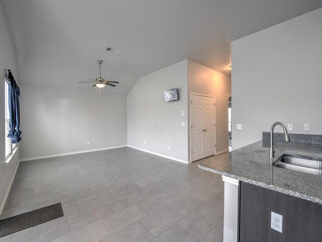 3635 W L Breeding Dr, Corpus Christi, TX 78414 - unfurnished living room with ceiling fan, lofted ceiling, arched walkways, and tile patterned flooring