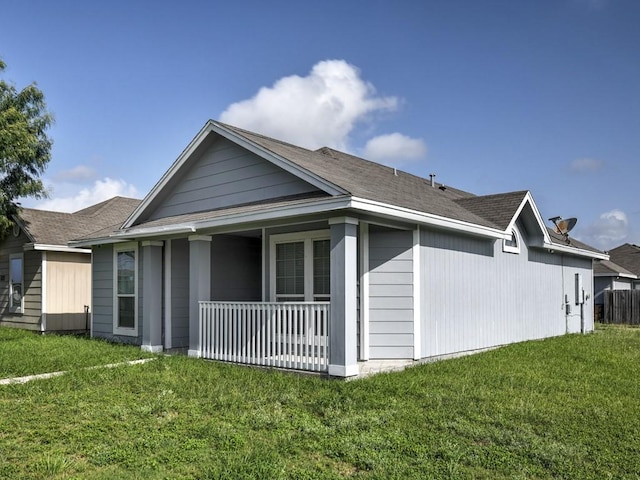 3635 W L Breeding Dr, Corpus Christi, TX 78414 - view of property exterior with a lawn, a porch, and roof with shingles