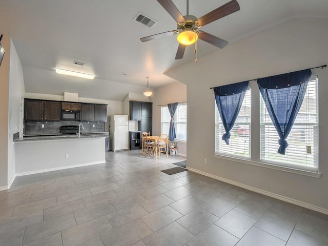 3635 W L Breeding Dr, Corpus Christi, TX 78414 - unfurnished living room with lofted ceiling, a ceiling fan, and tile patterned floors
