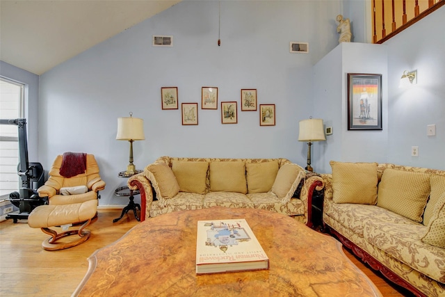 5651 Pine St, Houston, TX 77081 - living room featuring high vaulted ceiling and wood finished floors