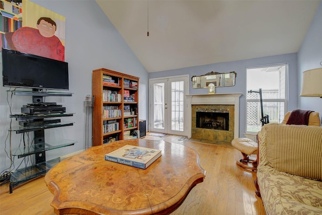 5651 Pine St, Houston, TX 77081 - living area featuring wood finished floors, a tiled fireplace, and high vaulted ceiling