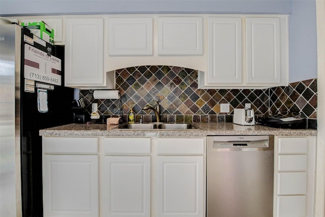 5651 Pine St, Houston, TX 77081 - kitchen featuring stainless steel dishwasher, freestanding refrigerator, backsplash, and white cabinets