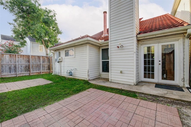 5651 Pine St, Houston, TX 77081 - rear view of property with a patio, a tiled roof, a chimney, and french doors