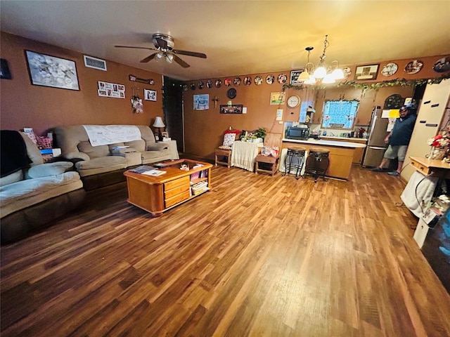 102 Draper St, Columbus, TX 78934 - living room with wood finished floors, a ceiling fan, and a chandelier