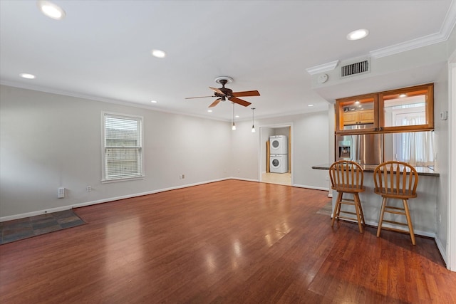 4206 Law St, Houston, TX 77005 - unfurnished living room featuring stacked washer / dryer, a ceiling fan, wood finished floors, recessed lighting, and crown molding