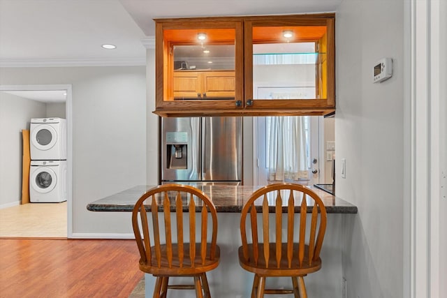 4206 Law St, Houston, TX 77005 - dining space featuring stacked washer and clothes dryer, crown molding, wood finished floors, and recessed lighting
