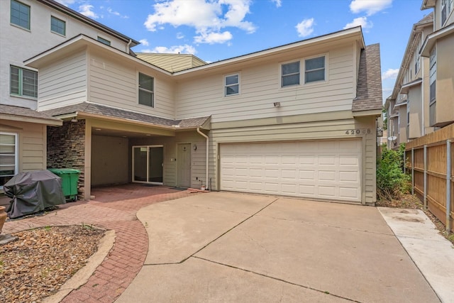 4206 Law St, Houston, TX 77005 - view of front of home with a garage, a shingled roof, stone siding, and concrete driveway