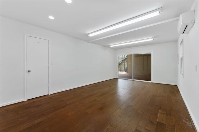 4206 Law St, Houston, TX 77005 - spare room with an AC wall unit, wood finished floors, and recessed lighting