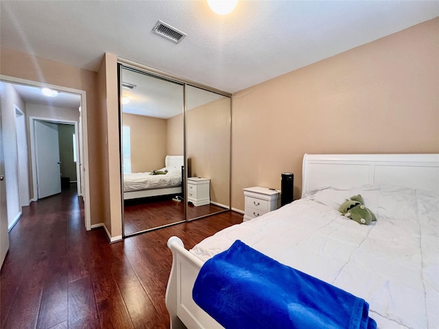 18738 Shannon Glen Ln, Houston, TX 77084 - bedroom with dark wood finished floors and a closet