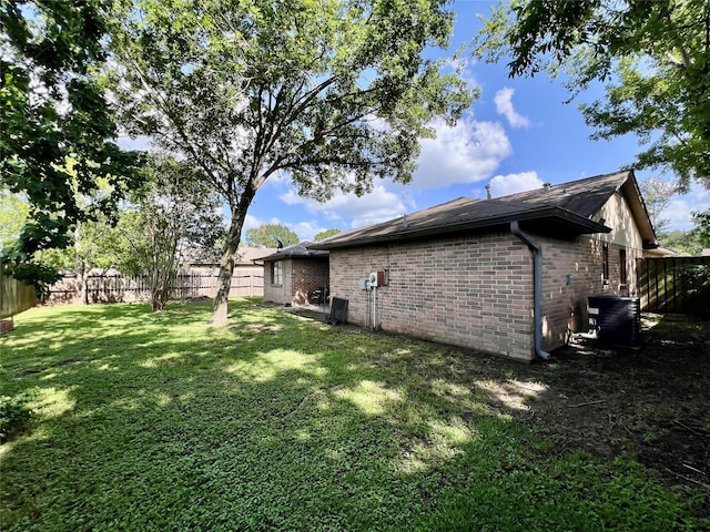 18738 Shannon Glen Ln, Houston, TX 77084 - view of property exterior featuring a fenced backyard, brick siding, and a shingled roof
