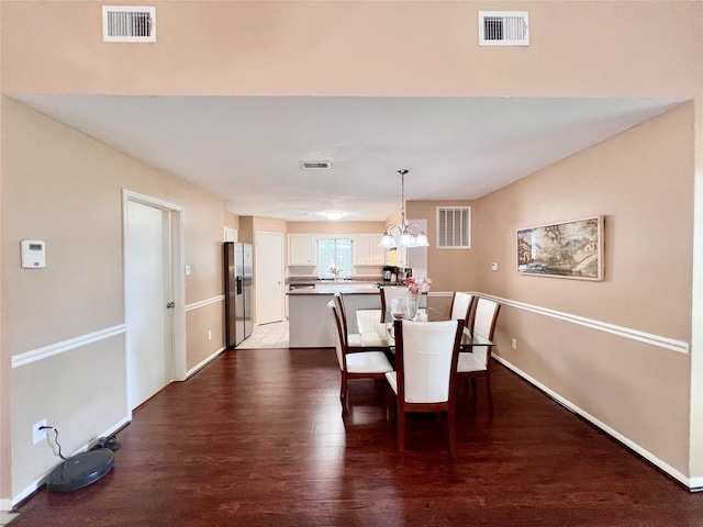 18738 Shannon Glen Ln, Houston, TX 77084 - dining area featuring a chandelier and dark wood-style floors