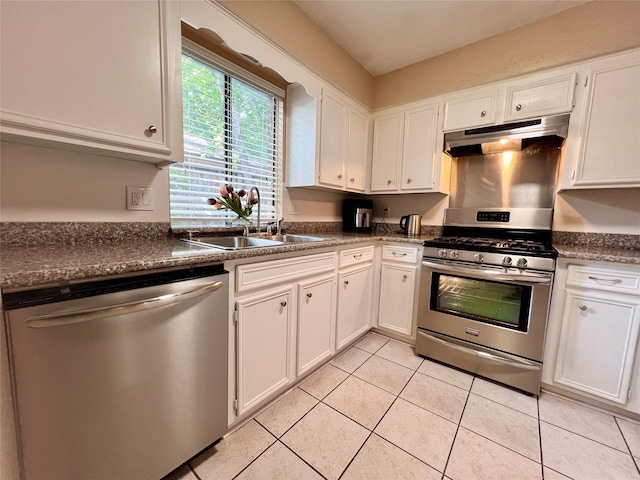 18738 Shannon Glen Ln, Houston, TX 77084 - kitchen with stainless steel appliances, under cabinet range hood, white cabinetry, and light tile patterned floors
