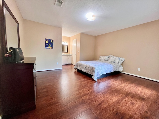 18738 Shannon Glen Ln, Houston, TX 77084 - bedroom with dark wood-type flooring and ensuite bath