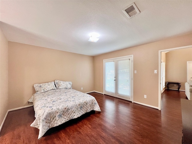 18738 Shannon Glen Ln, Houston, TX 77084 - bedroom with dark wood-style flooring, french doors, and a textured ceiling
